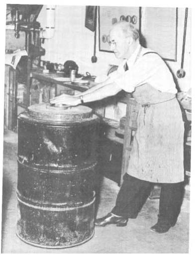 Plate IV. Polishing the mirror is a delicate operation. Note the position of the arms, and the stance, different from those used in the grinding operation in Plate III.